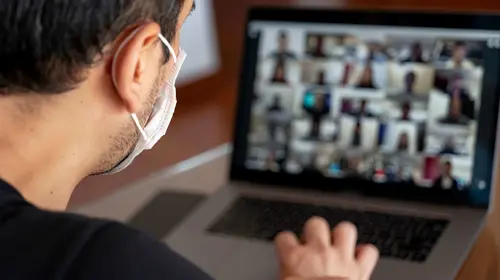 Man using a mask and having a video conference