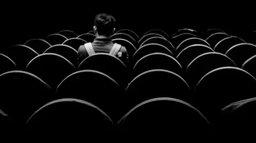 Man sitting alone in a theatre