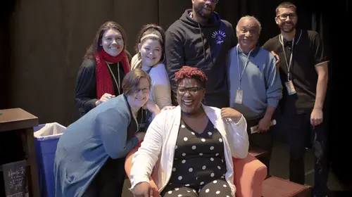 A group of seven people smiling